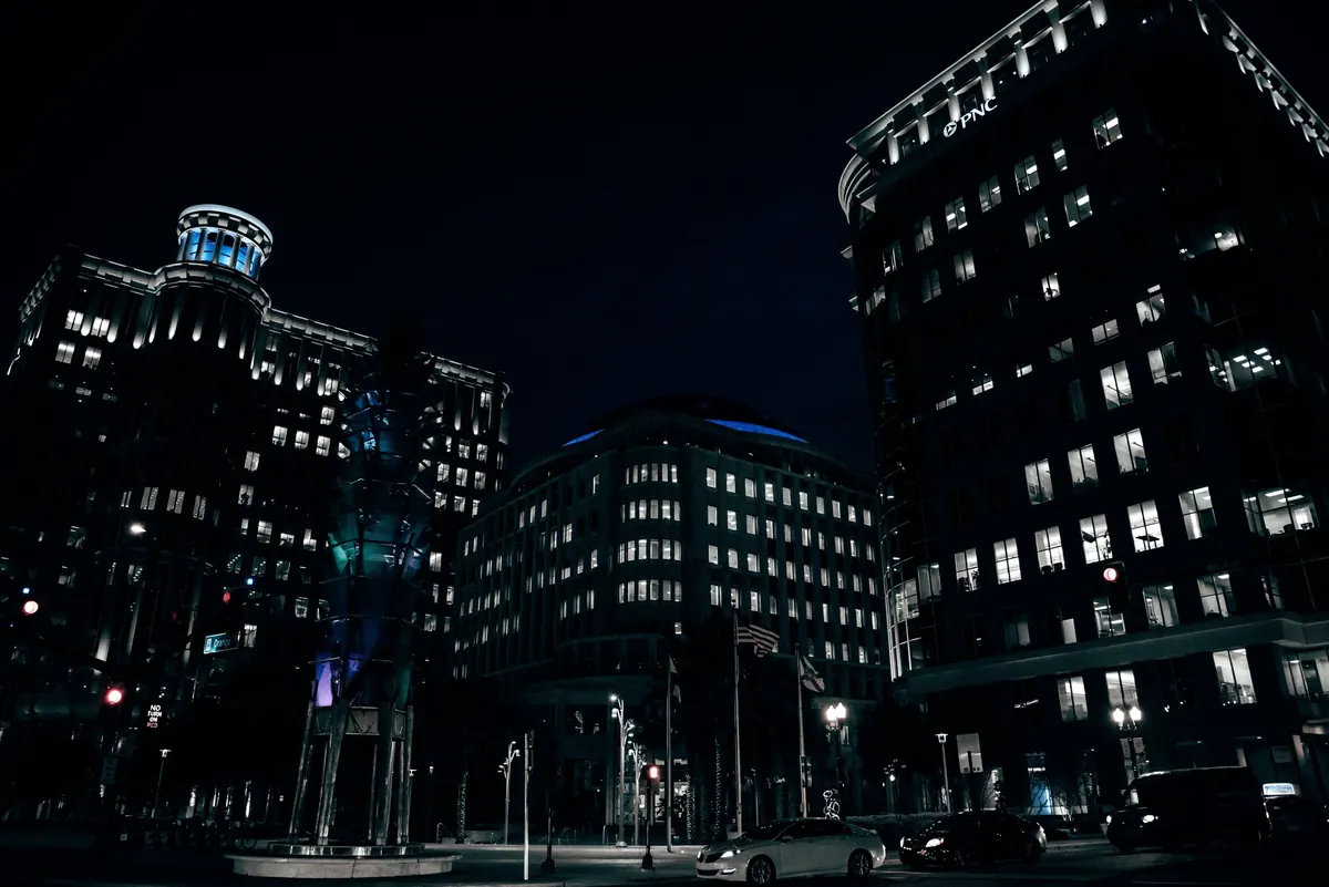 Office buildings lit up at night in a downtown business district