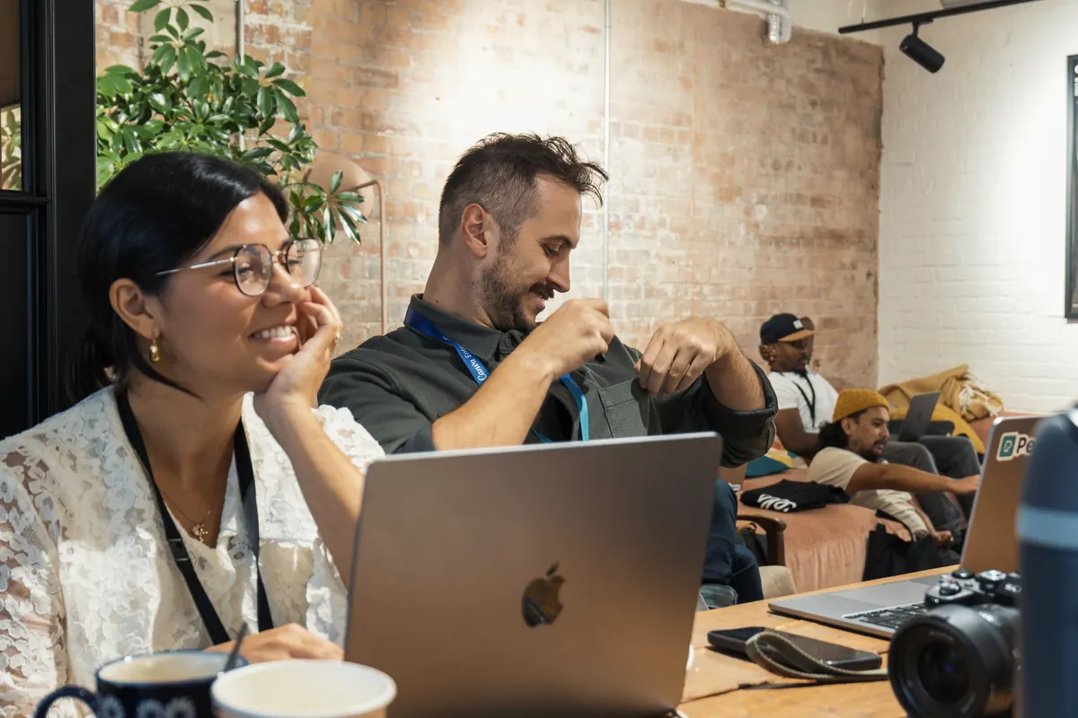 Team meeting around laptops in a bright office